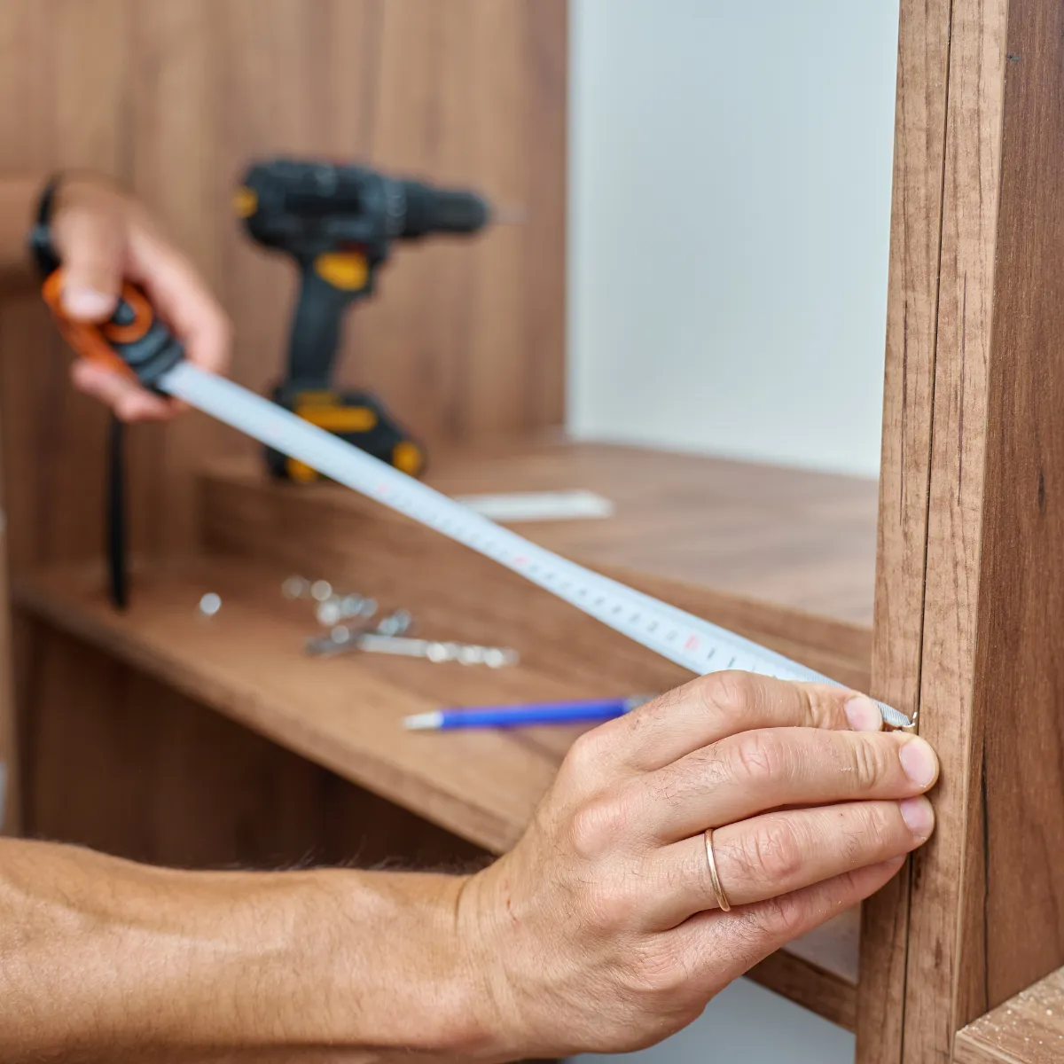Bars Property Services team member measuring and assembling wooden shelving during a home improvement project in Halifax