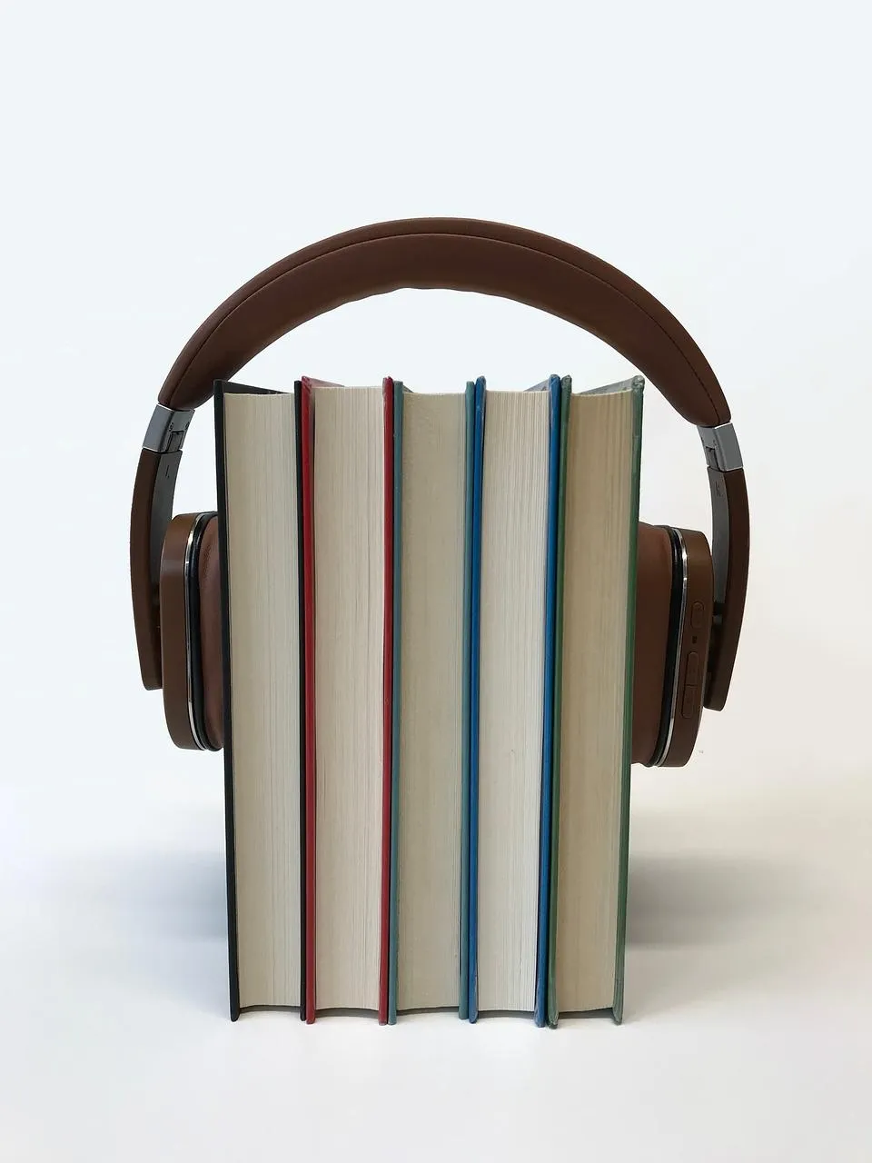headphones surrounding books to show that you can listen to your books