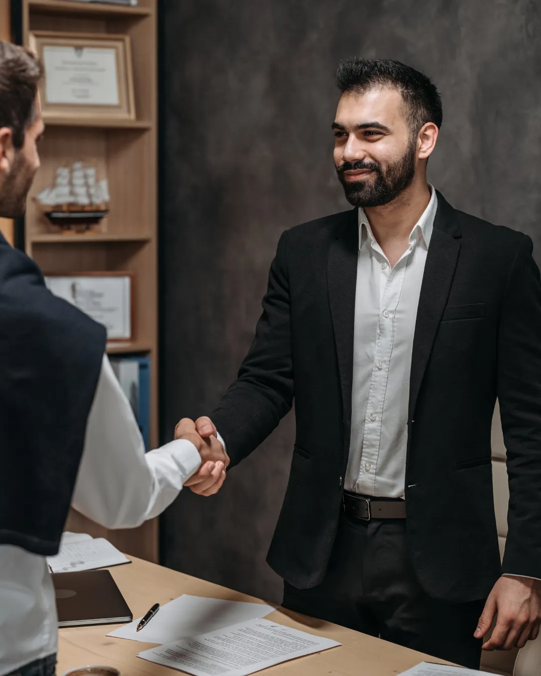 Several gold bars stacked on a dark surface