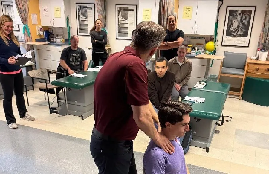 Mulligan with Movement USA instructor demonstrating Mulligan Concept foot mobilization.