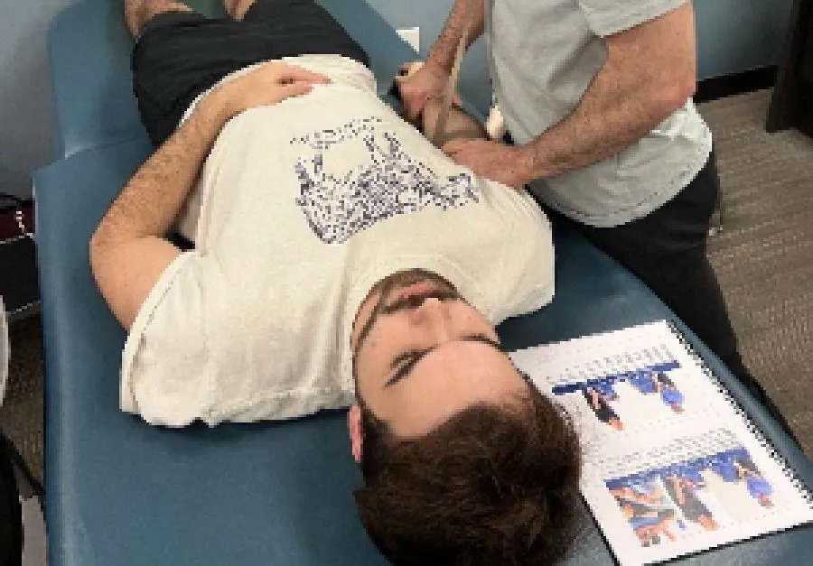 Mulligan with Movement USA instructor demonstrating Mulligan Concept hip mobilization.