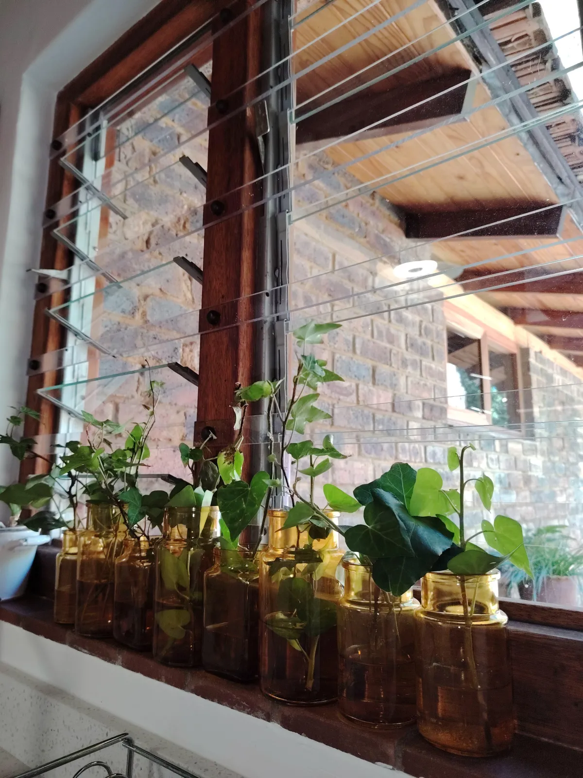 calm body of water near brown mountain under white and gray sky