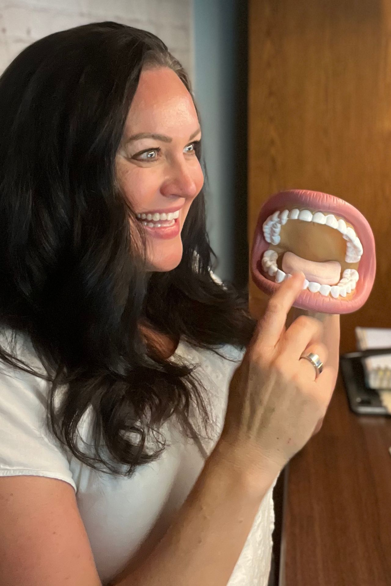 Carmen Ball demonstrating tongue posture using a dental model during myofunctional therapy training