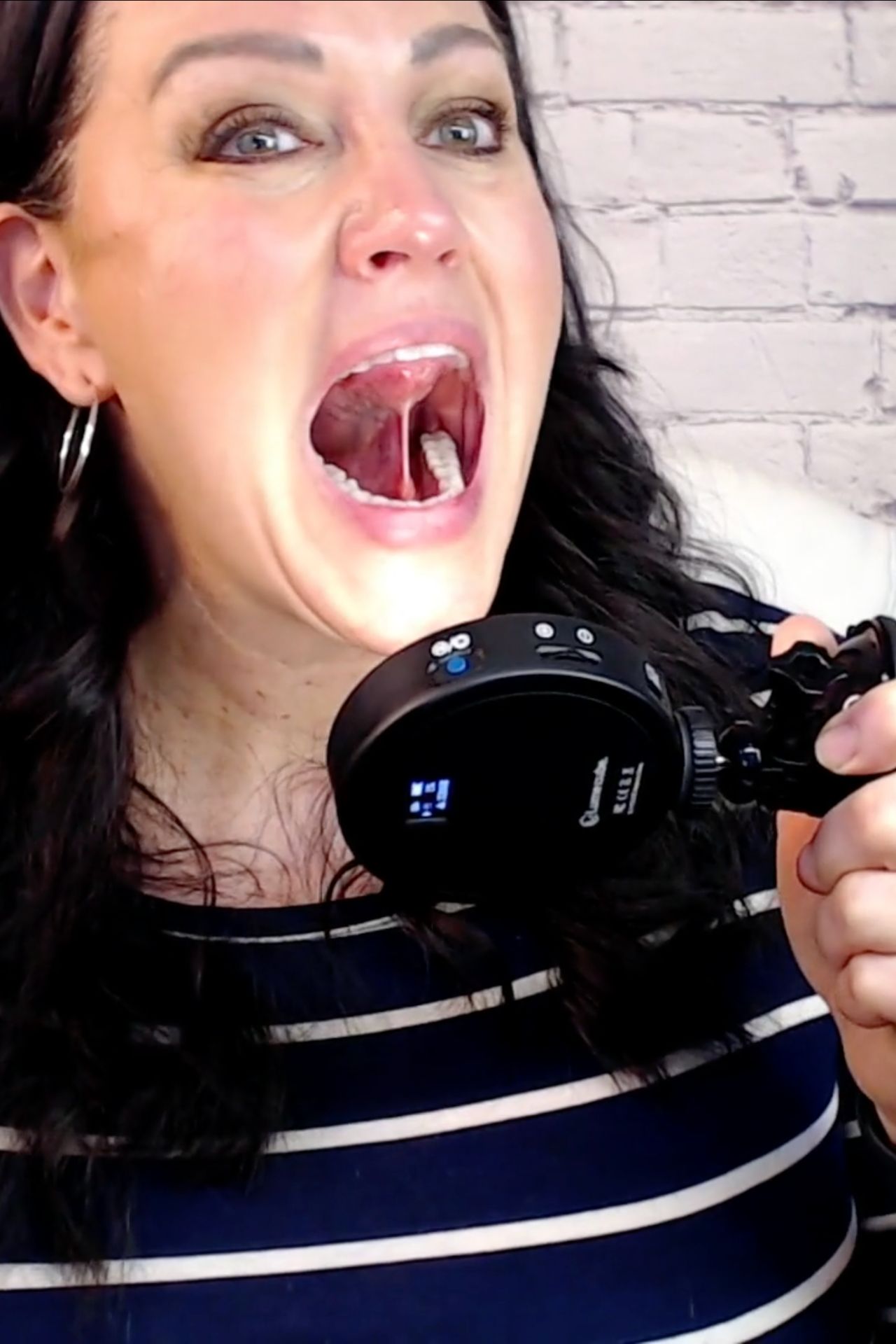 Carmen Ball demonstrating tongue tie evaluation using an oral exam light during myofunctional therapy training