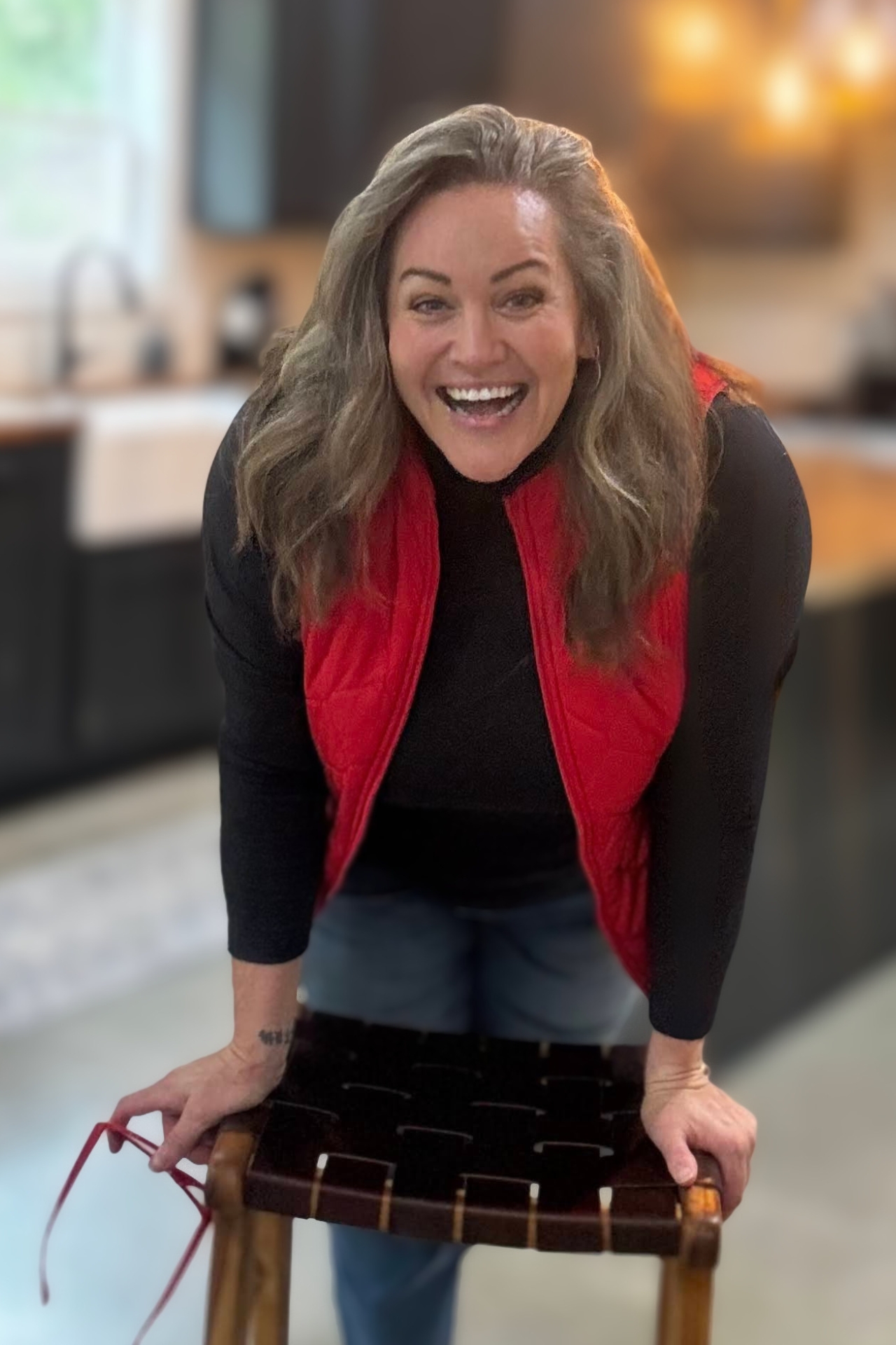 Carmen Ball smiling and holding a bag