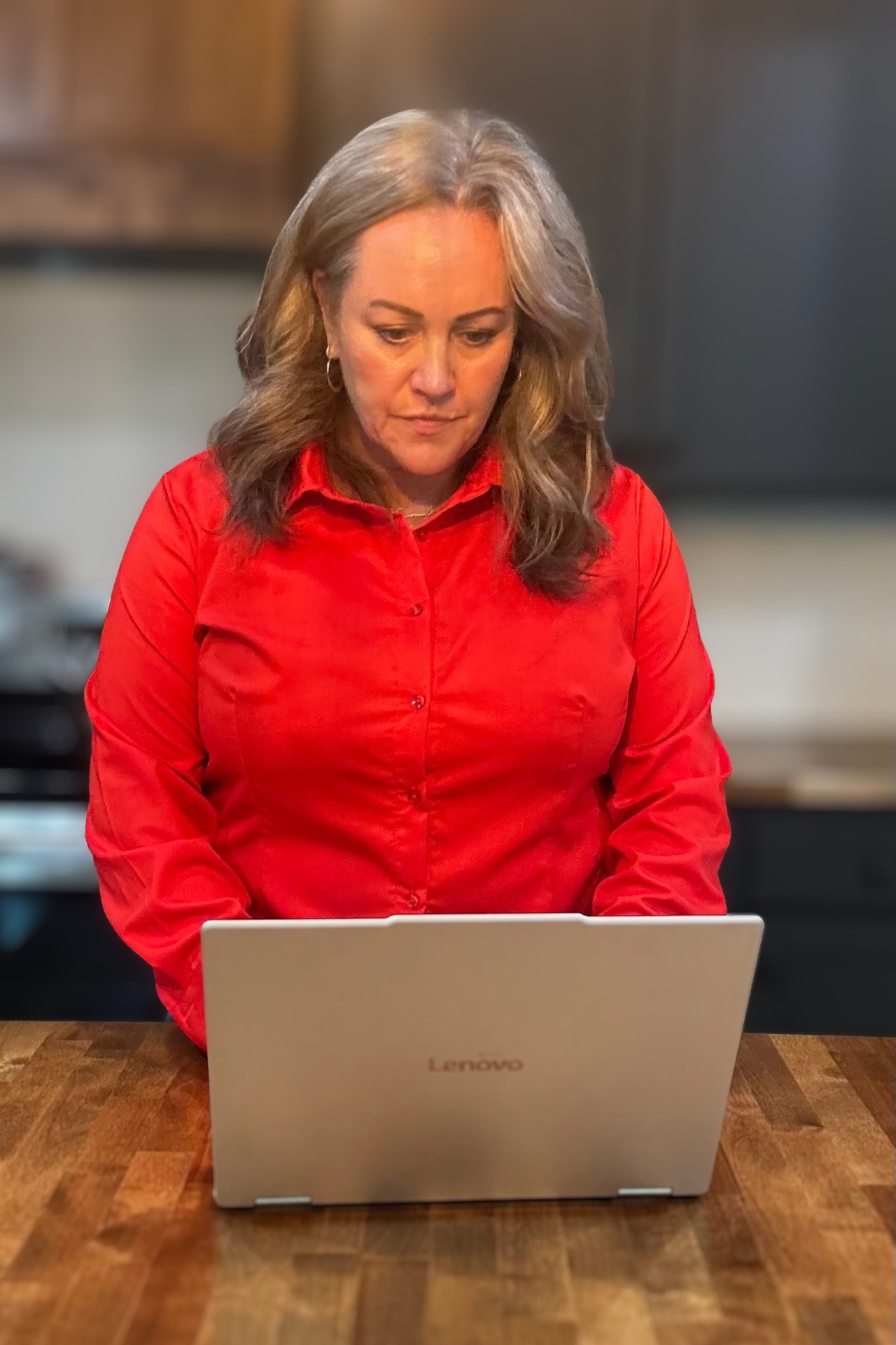 Carmen Ball working at a desk with a laptop