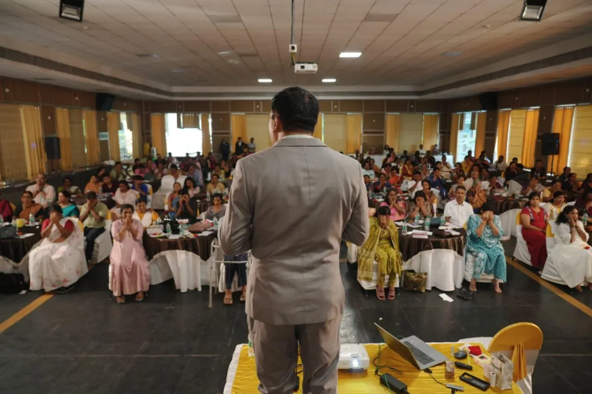 a man sitting on the ground in front of a building