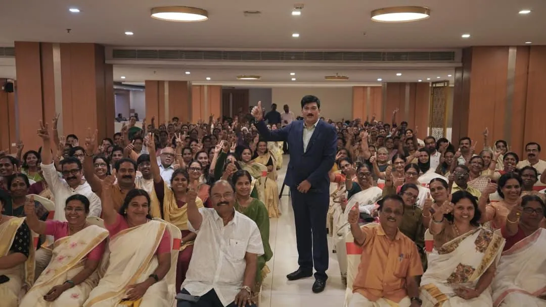 a man sitting on the ground in front of a building