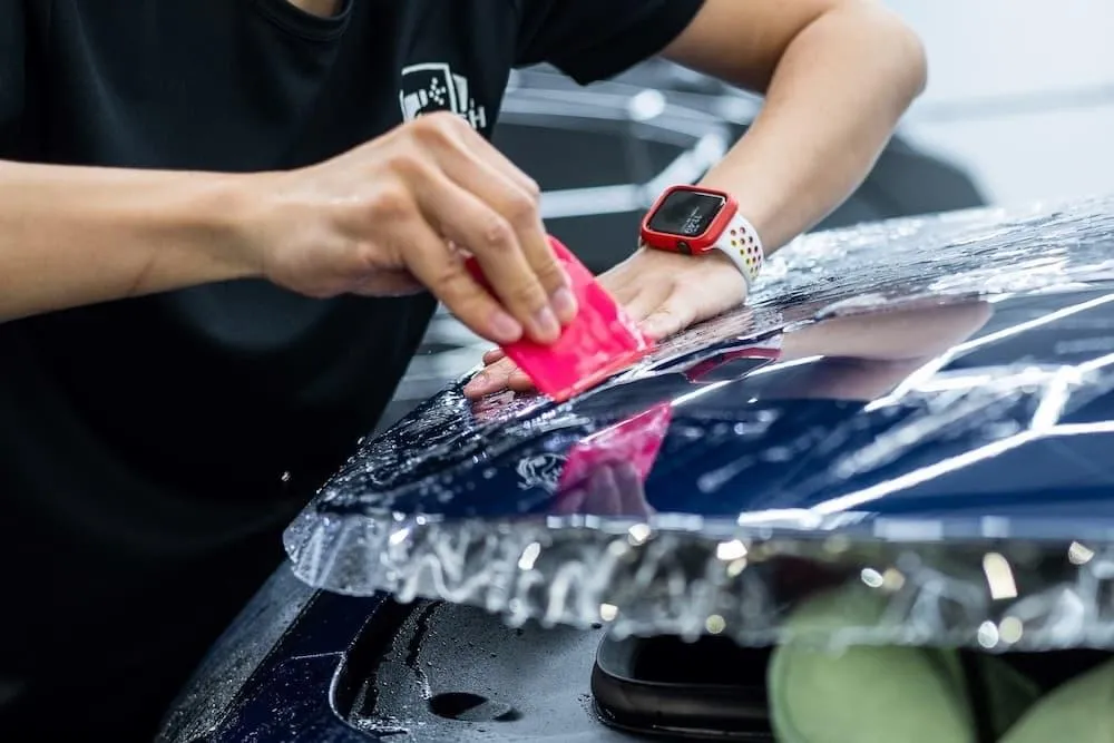 Paint protection film application on a car bonnet