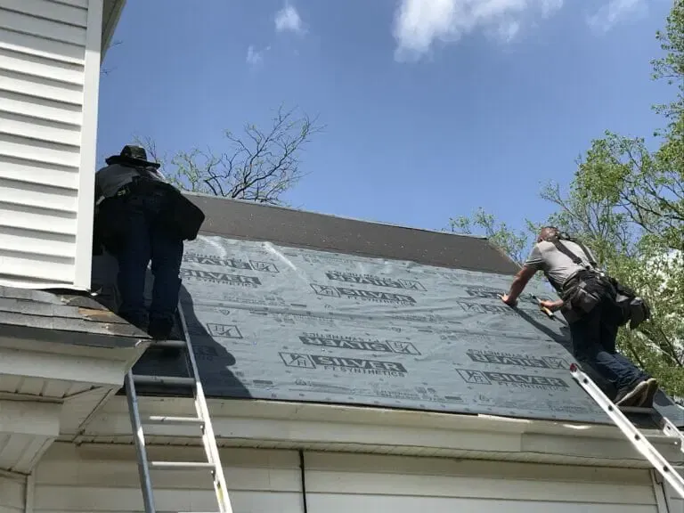 two professionals installing new roof