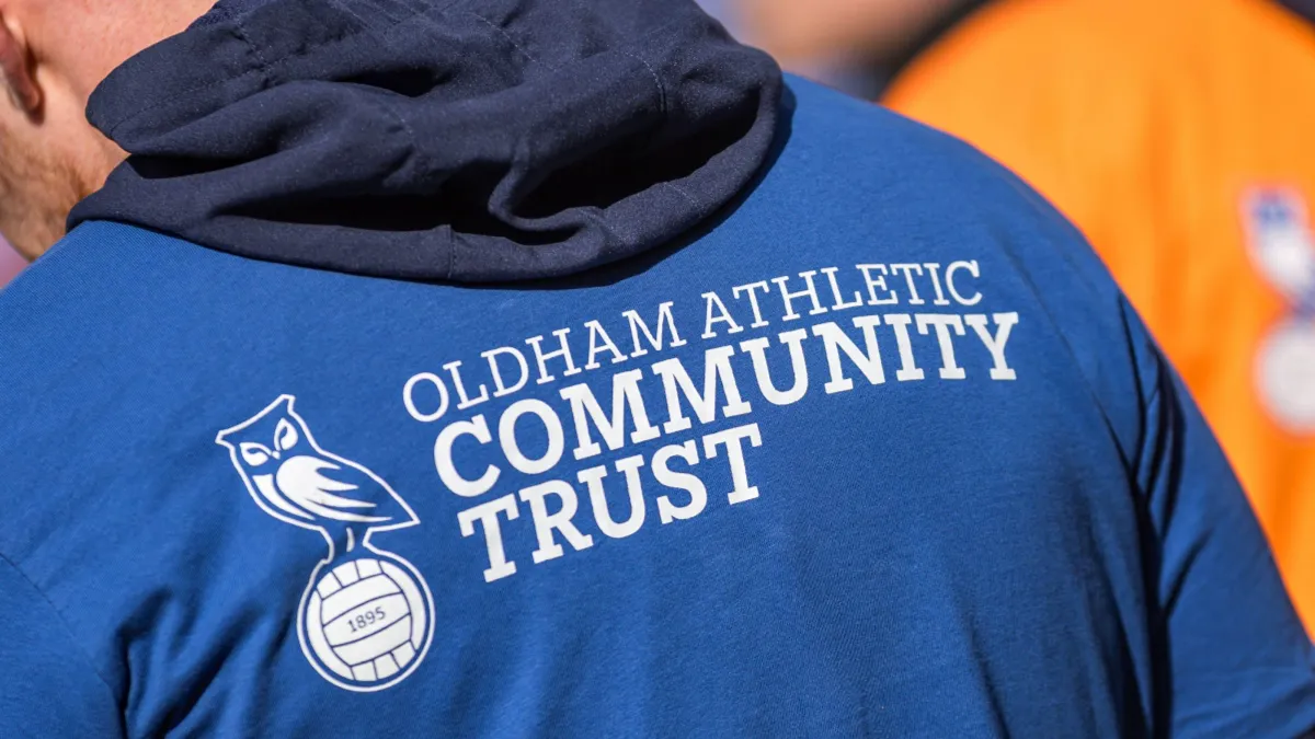 a room filled with wooden desks and chairs