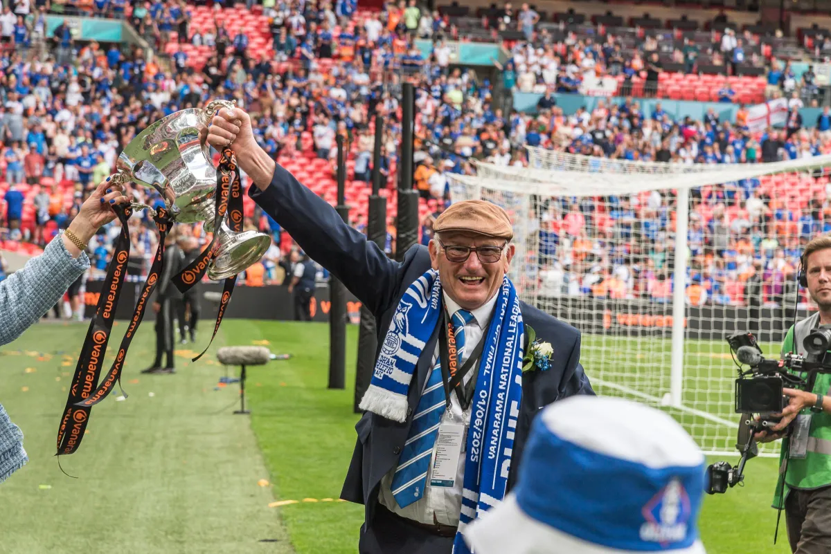 close-up photo of books in brown wooden shelf