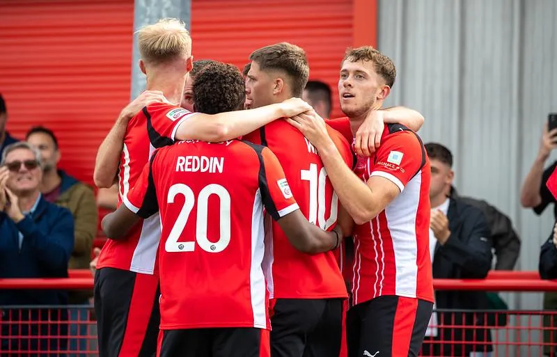 a room filled with wooden desks and chairs