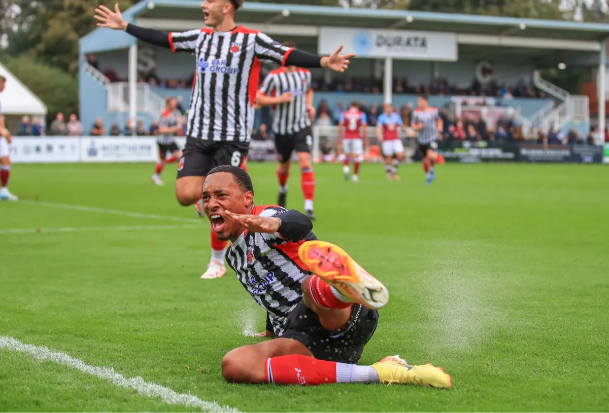 a room filled with wooden desks and chairs