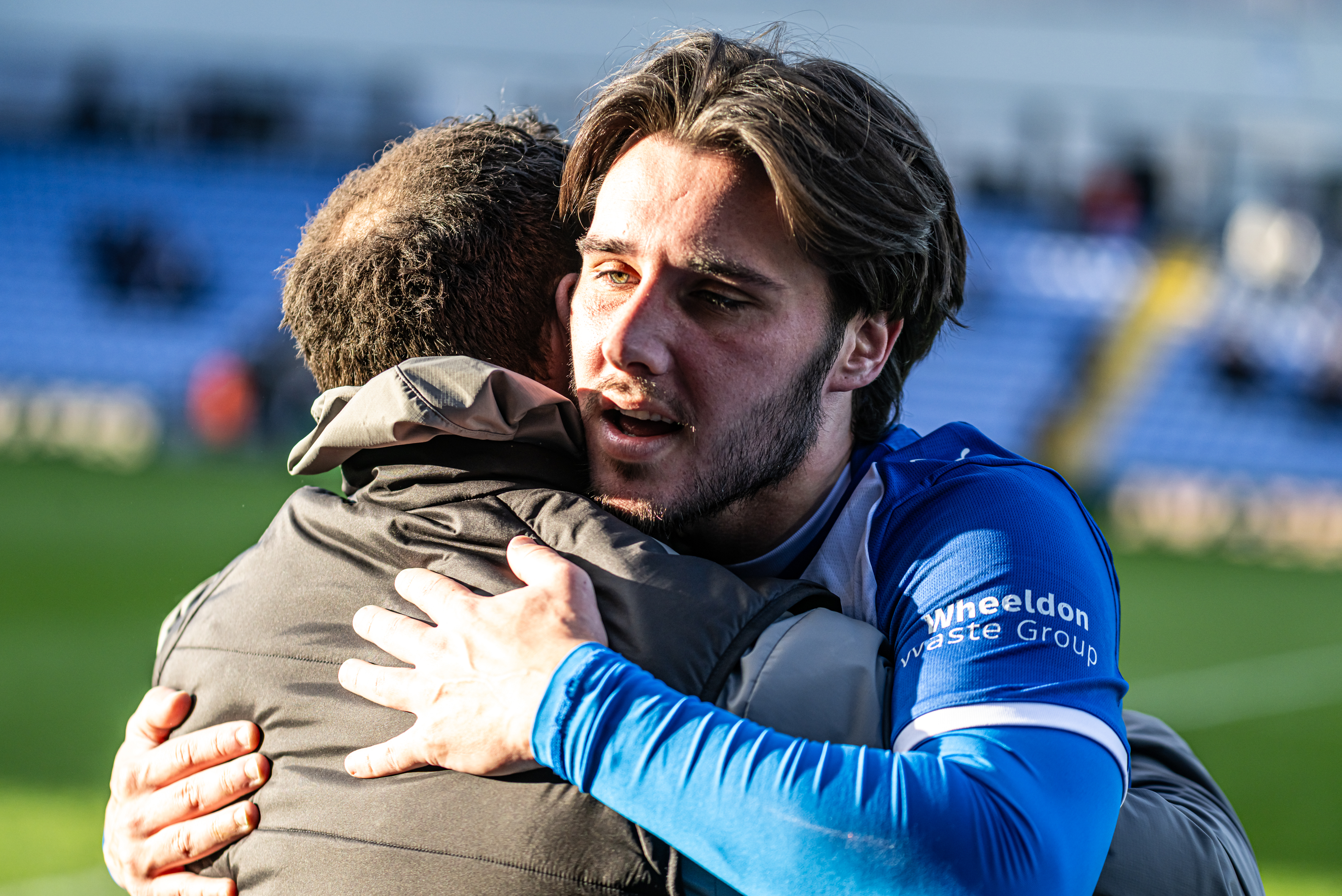 close-up photo of books in brown wooden shelf