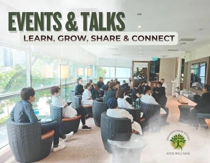 Image for "EVENTS & TALKS: LEARN, GROW, SHARE & CONNECT," showing a group of people attending an ATOS Wellness seminar or workshop in a bright, modern room with large windows.