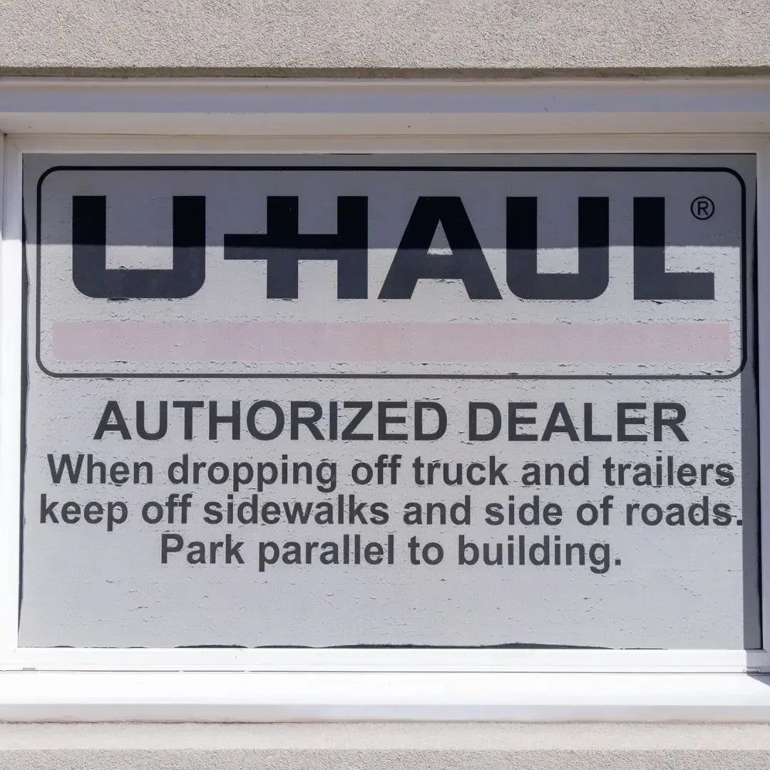 U-Haul authorized dealer sign at Pearson Auto Syracuse storefront