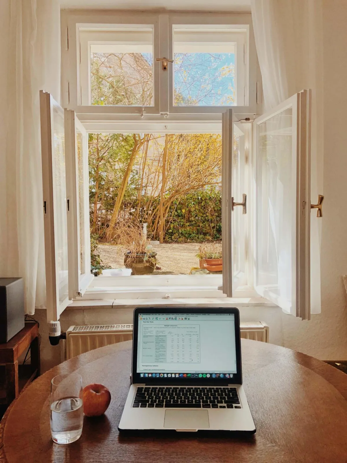 laptop on table open in front of window