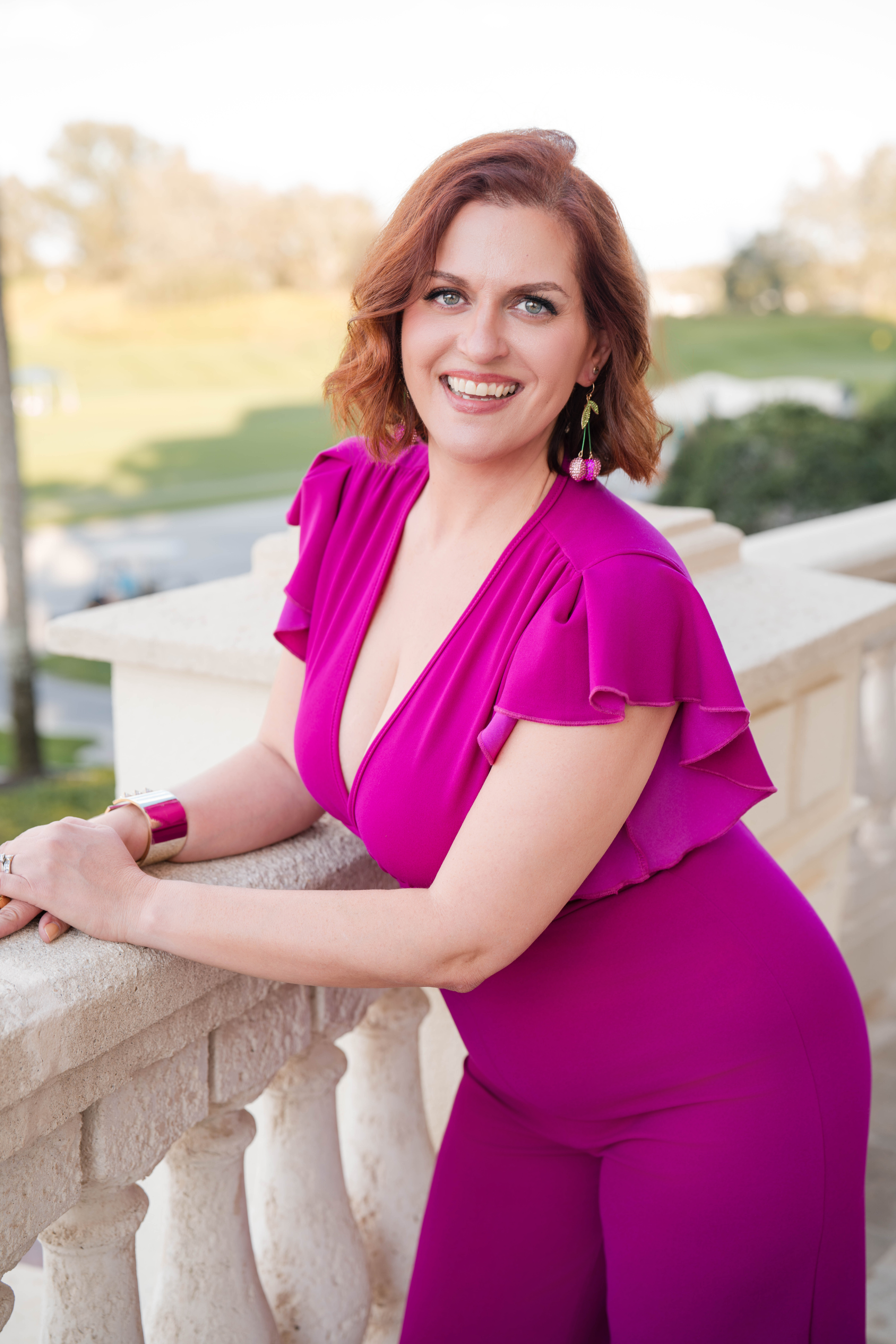 Diane Vich in purple standing at the terrace with a big smile