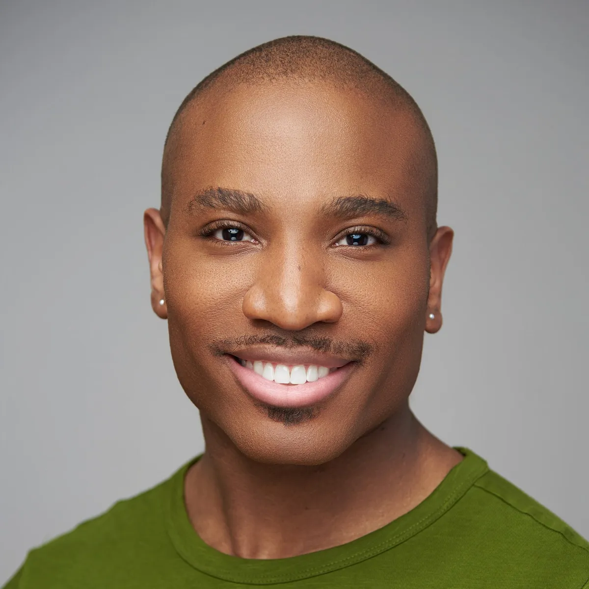 Smiling man on a green backdrop