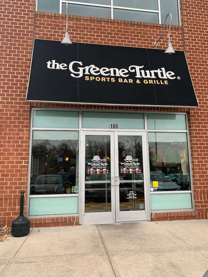 Brand graphic for The Greene Turtle Sports Bar & Grille featuring the establishment name alongside a prominent "100" element, likely indicating a location number, anniversary, or milestone.