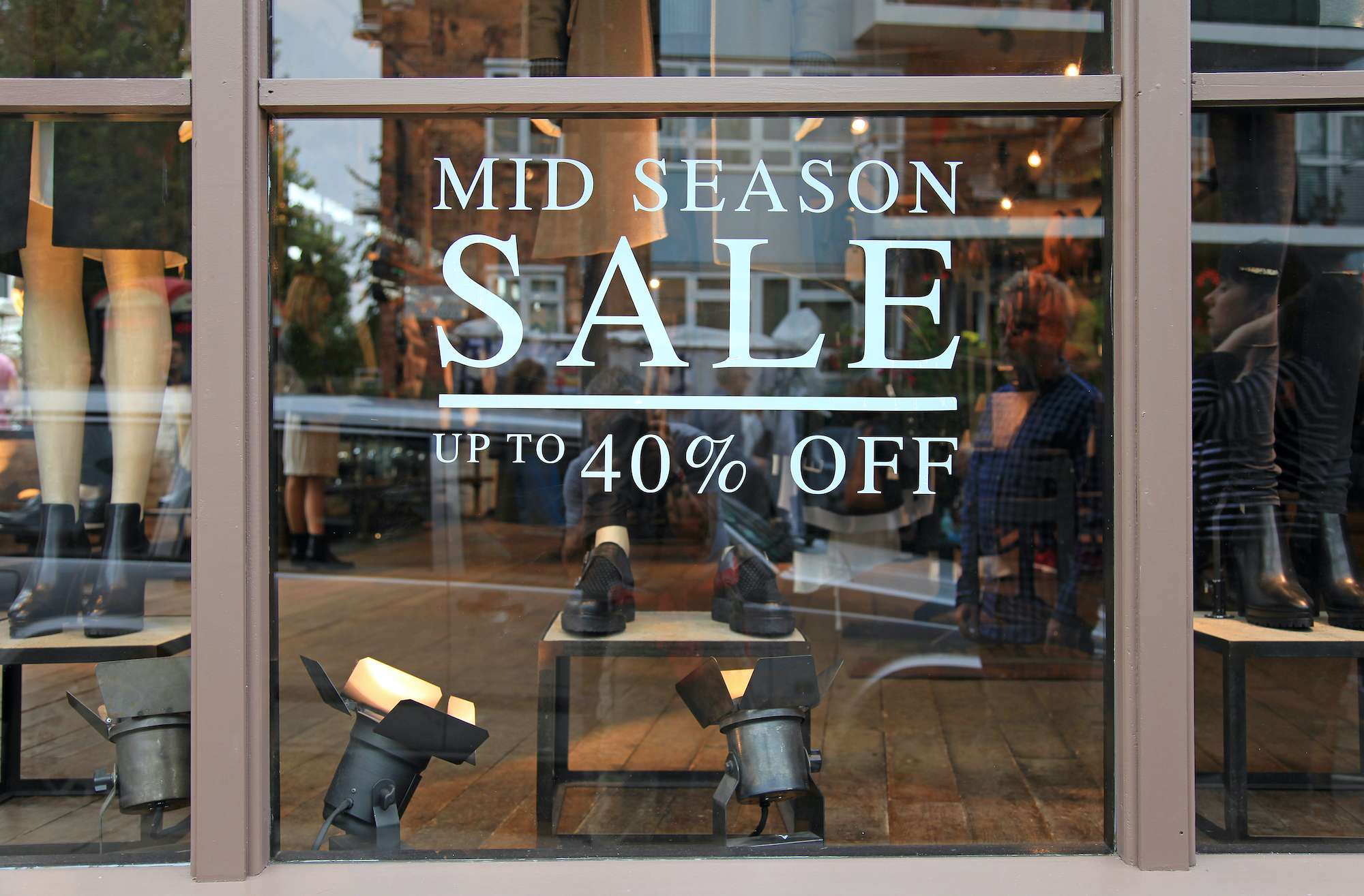 Promotional sale sign reading "Mid Season Sale, up to 40% off" in stacked text format, advertising a limited-time discount event.