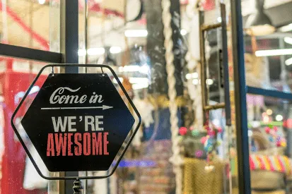 Playful business welcome sign reading "Come in, we're awesome" in stacked text format, conveying a friendly and confident brand personality.