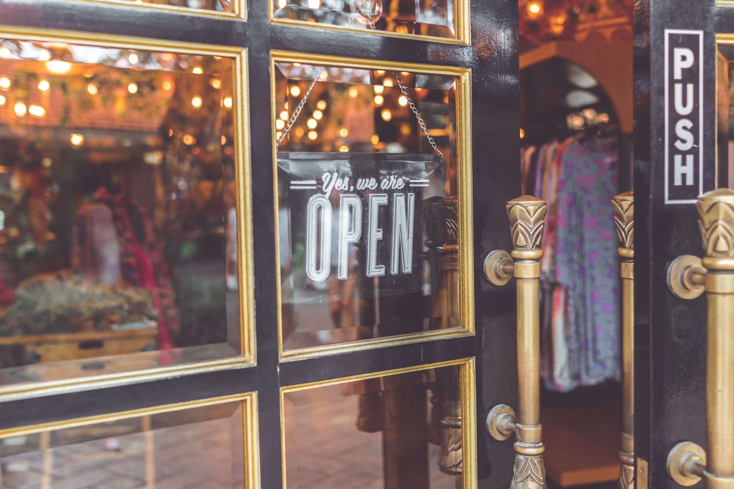 Graphic with the headline "Seven Ways to Support Your Small Businesses During COVID-19" alongside a "Yes, we are OPEN" message.