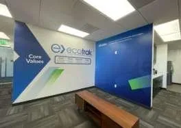 Ecotrak Facility Management Software office branding wall with core values and mission statement in a modern corporate interior