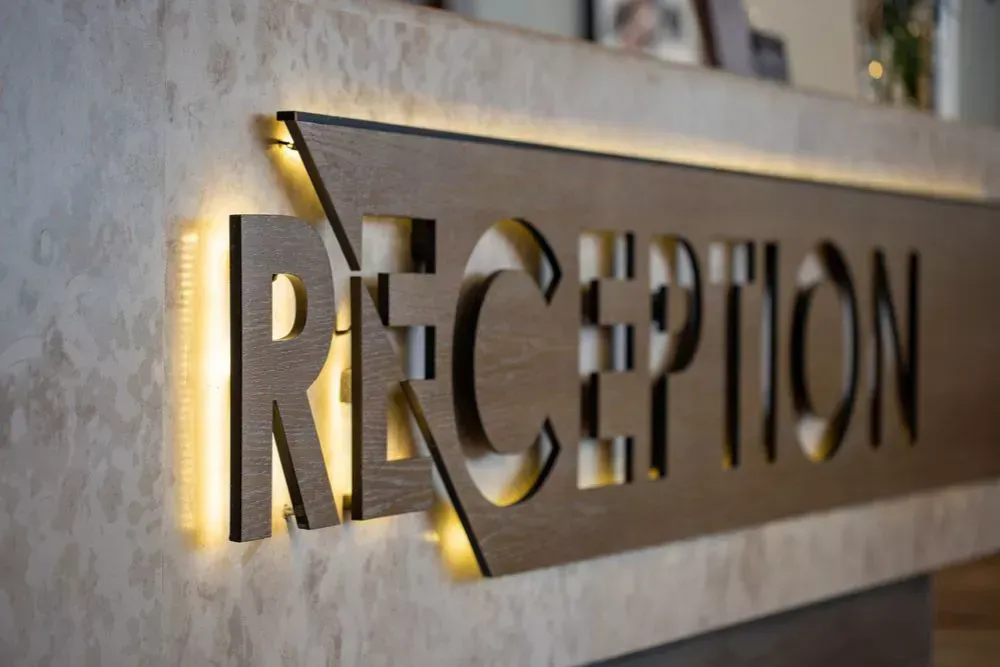 Modern illuminated reception sign mounted on a lobby wall, used for professional lobby signage, office reception branding, and welcoming visitors at a business entrance.