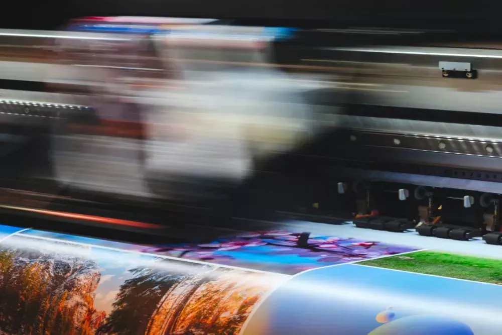 Large format printer producing custom printed backdrop graphics for events, trade shows, and branded photo backdrops used for marketing displays and event branding.