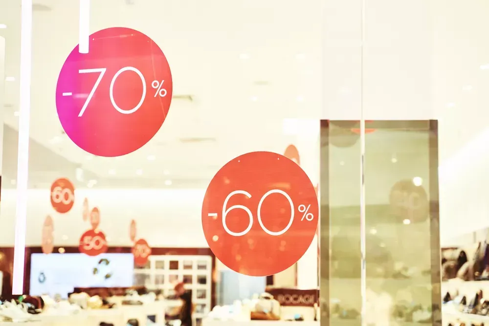 Retail storefront window graphics displaying promotional sale decals with “70%” and “60%” discounts, used for retail window signage, store promotions, and attracting customer attention.