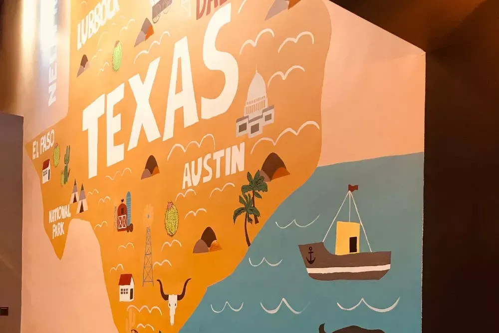 Custom Texas themed wall mural featuring Austin landmarks and illustrations, used for branded wall murals, interior storytelling graphics, and decorative business wall art.