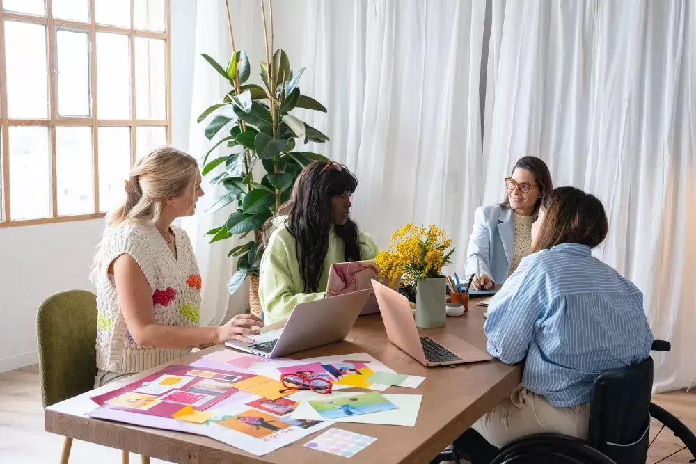Marketing team collaborating on brand strategy and design materials, used to represent business rebranding, signage redesign planning, and brand identity development for companies.