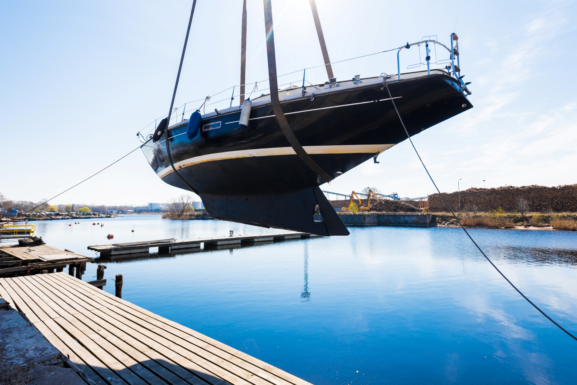 Boat lifted above the water at a marina dock with custom graphics wrap