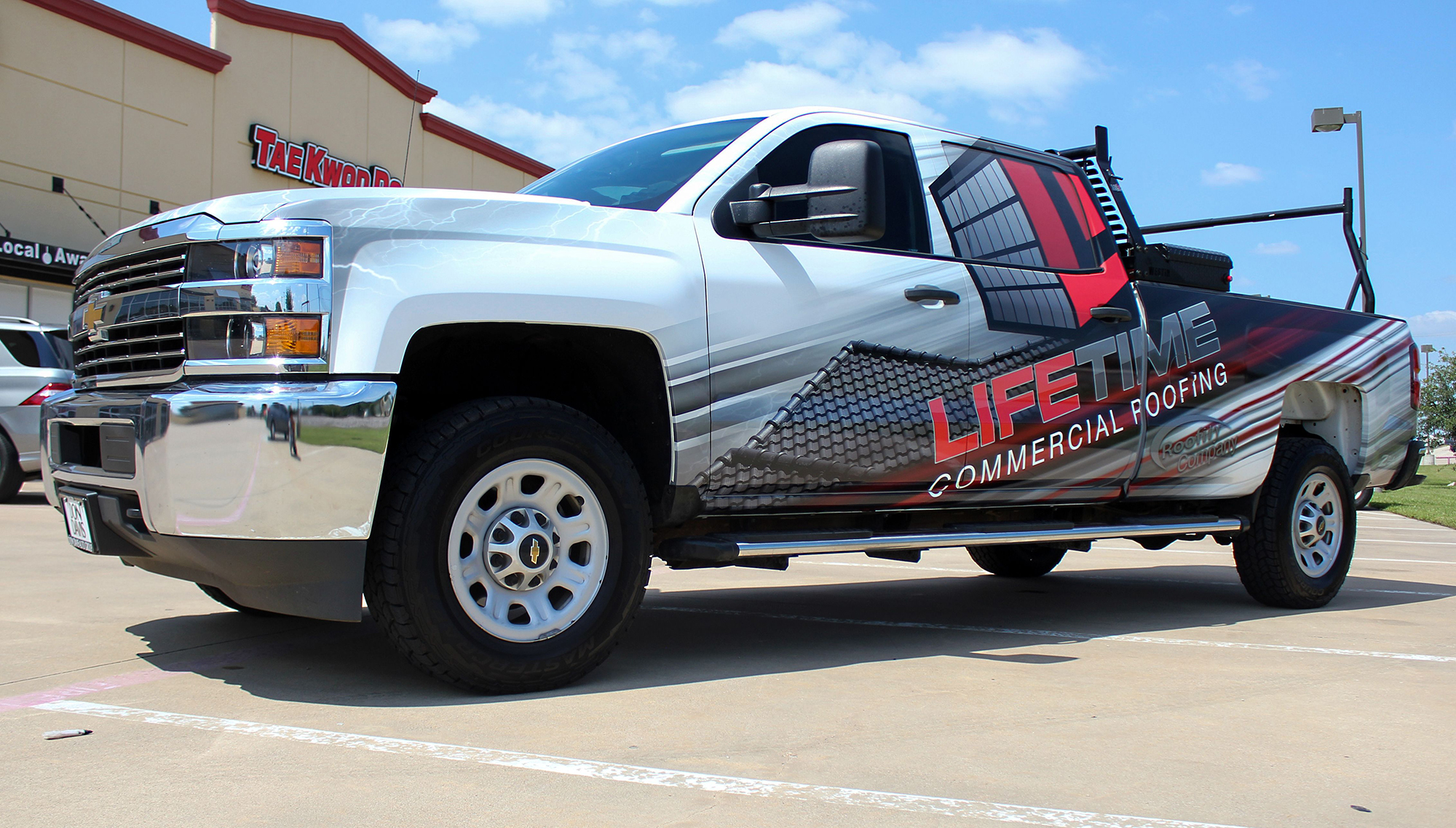 Pickup truck with custom branded vehicle graphics and partial wrap on the side