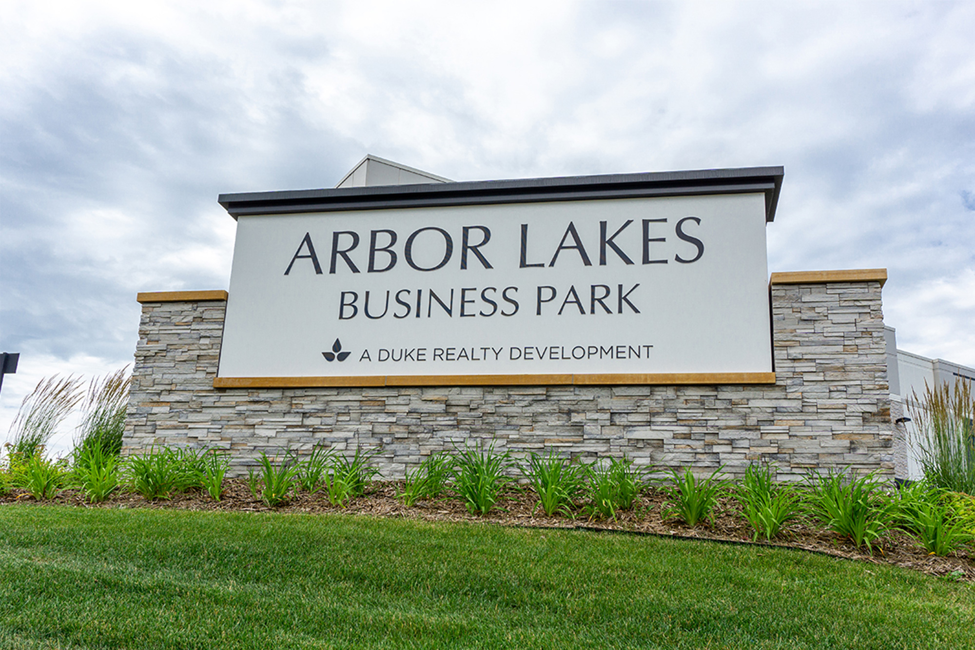 Arbor Lakes Business Park monument sign at landscaped entrance
