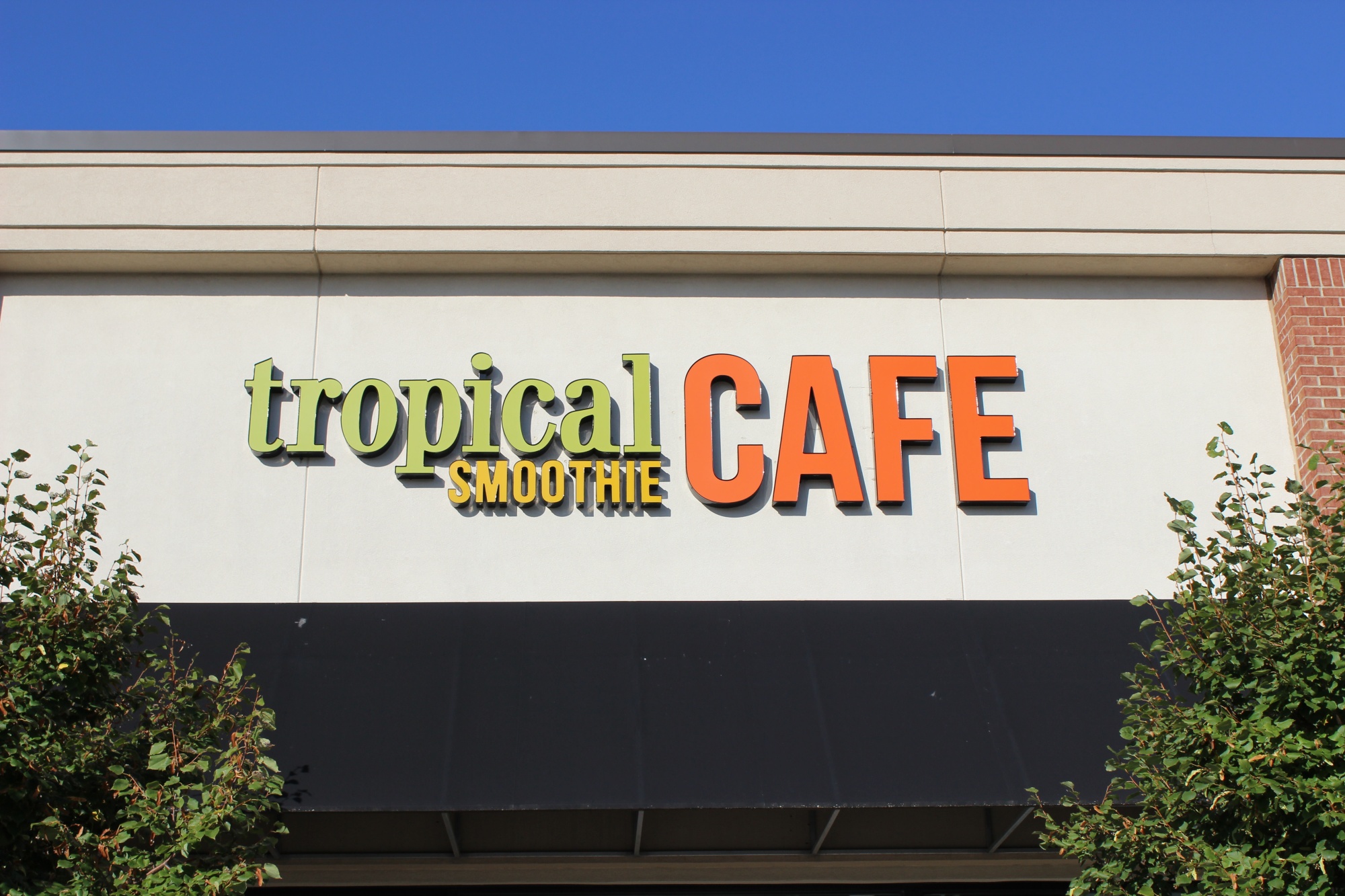 Tropical Smoothie Cafe storefront sign mounted on building facade
