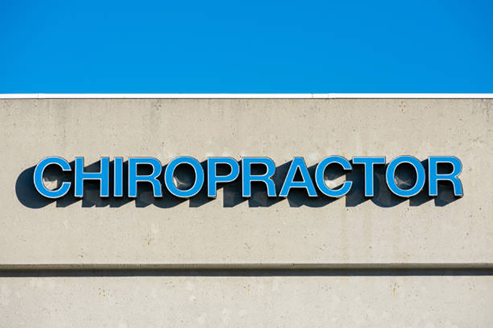 Blue channel letter chiropractor sign mounted on medical office building
