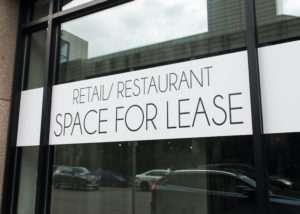 Retail restaurant space for lease window sign on commercial building