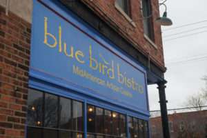 Blue Bird Bistro restaurant storefront sign mounted on building
