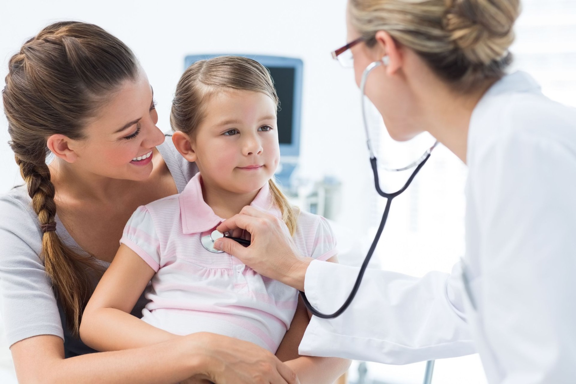 Pediatric doctor examining child during medical appointment