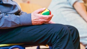 Occupational therapy patient holding therapy ball during rehabilitation session