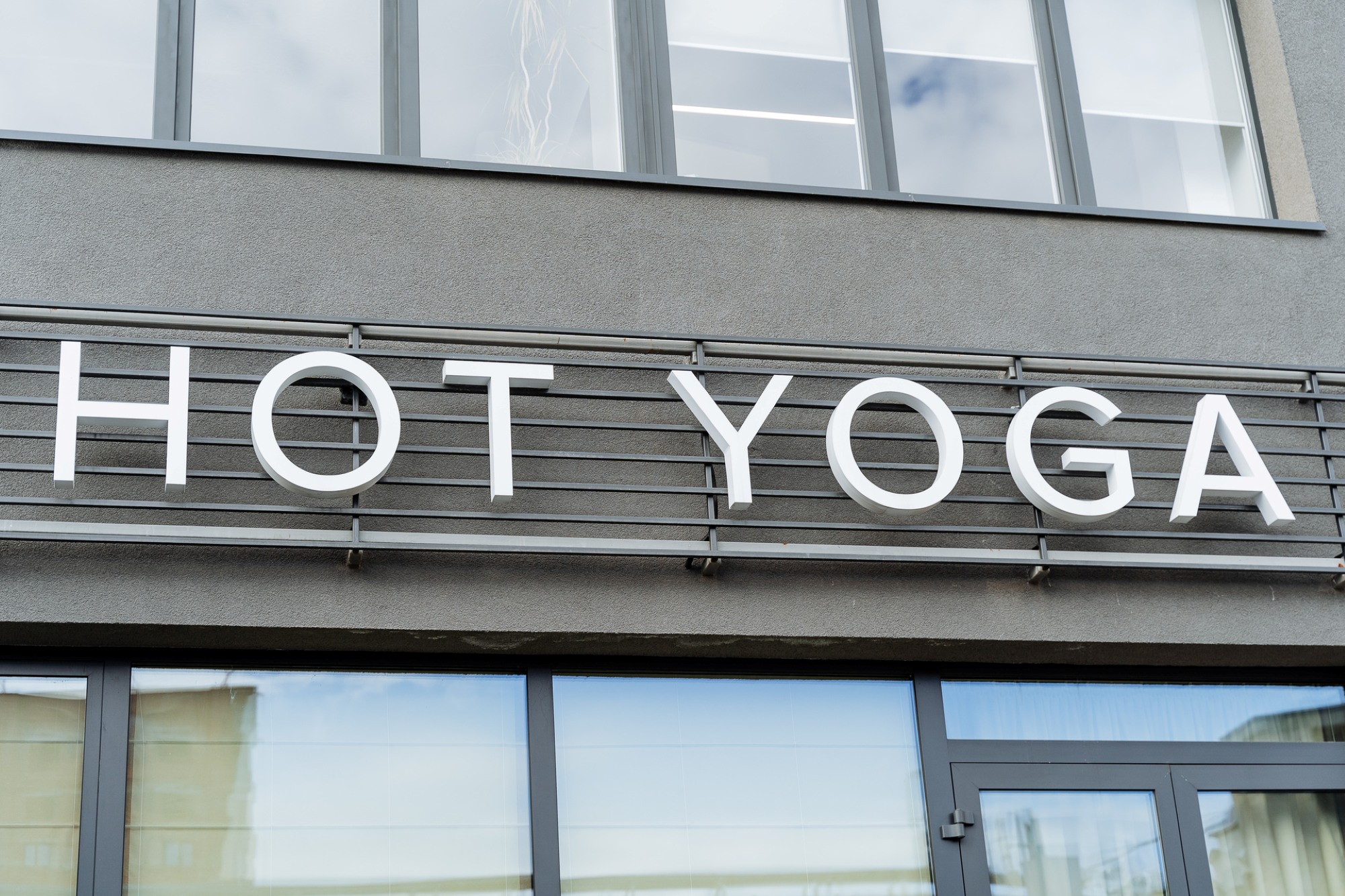 Modern yoga studio storefront entrance signage
