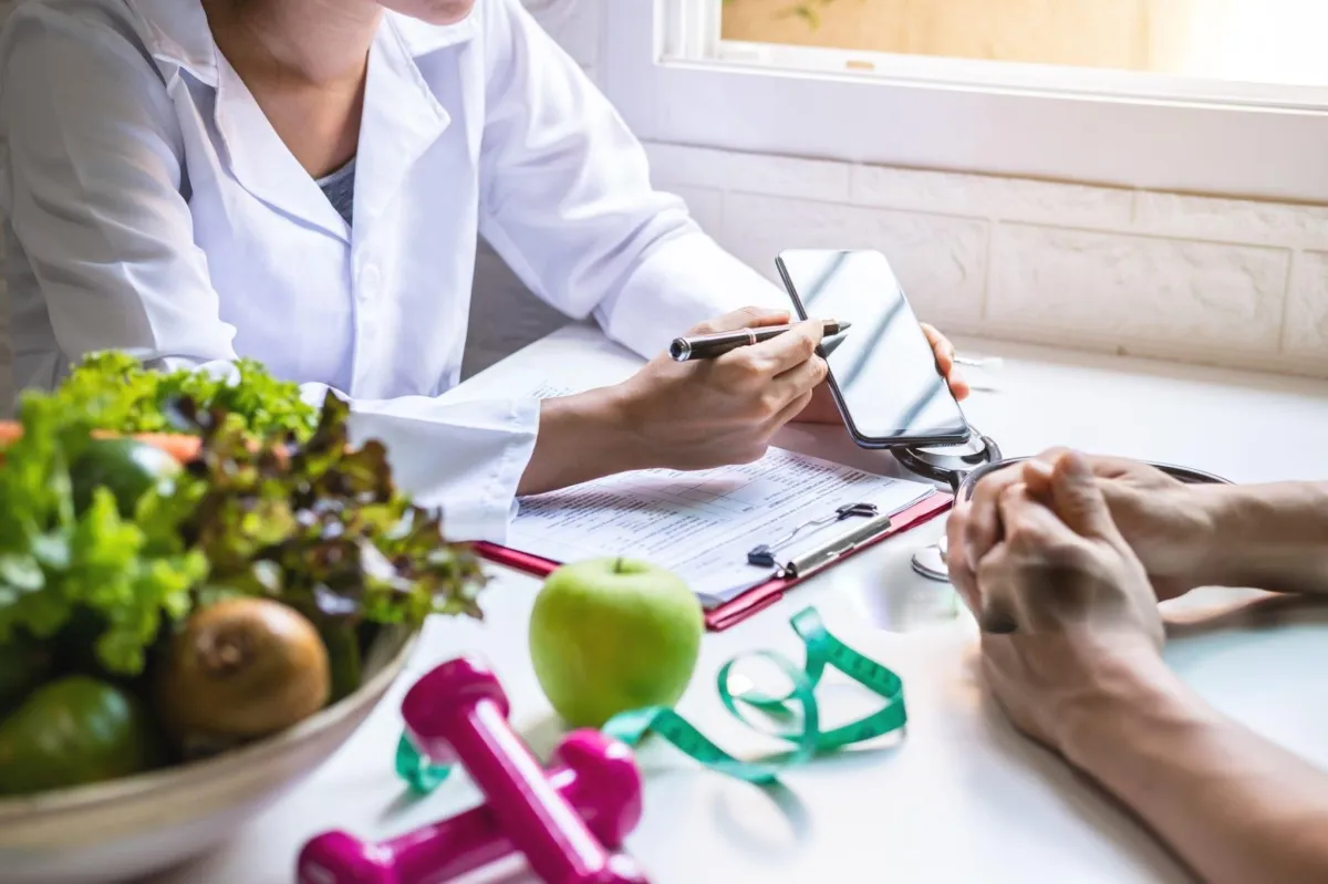 man in purple suit jacket using laptop computer
