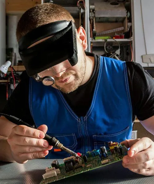 Expert technician repairing smartphone motherboard with precision soldering at Cellular Repair 1