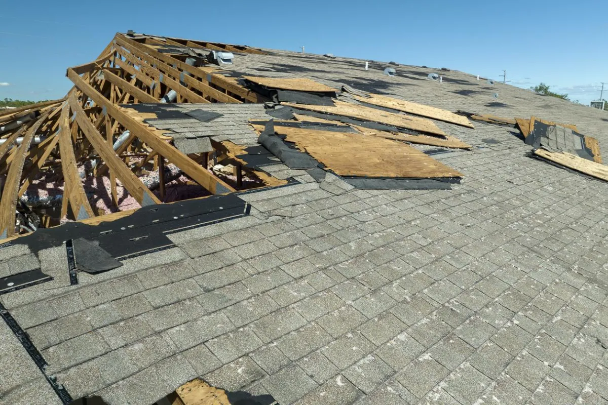 Severely damaged roof from a storm being restored in , provided by the professionals at .