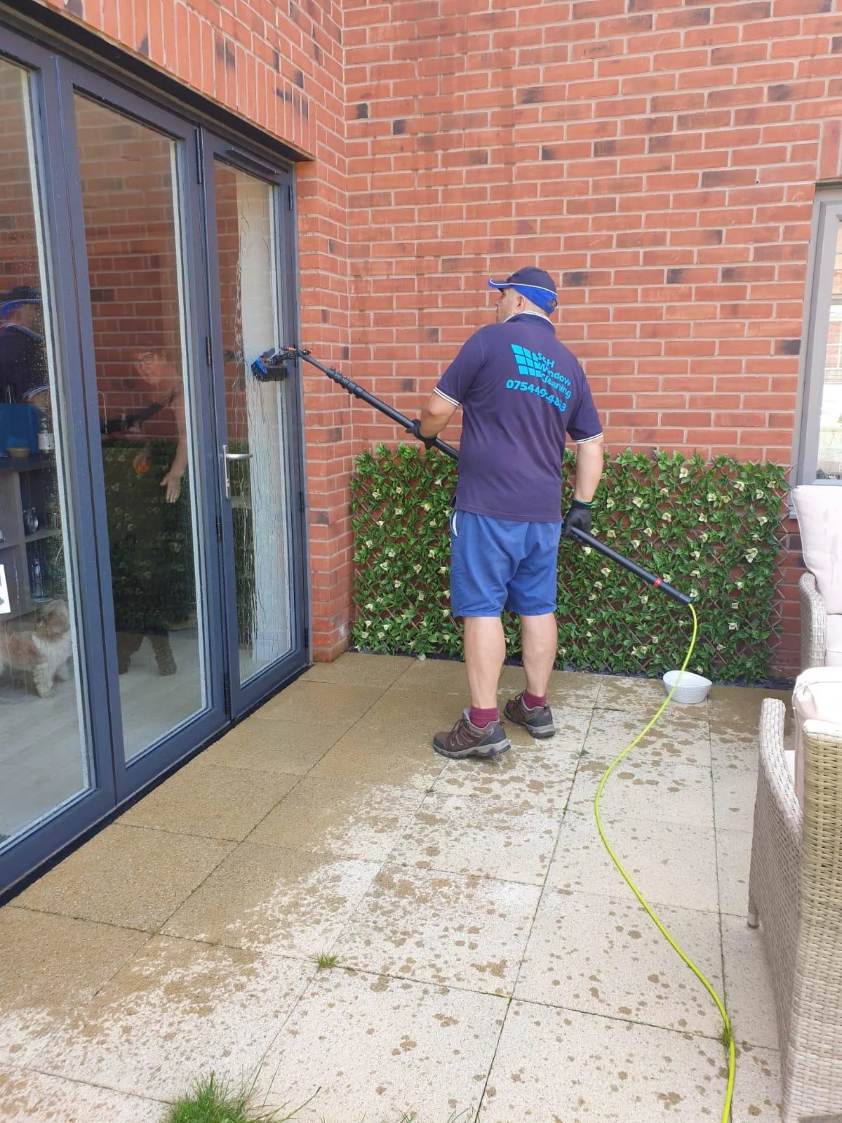 Team member cleaning windows 