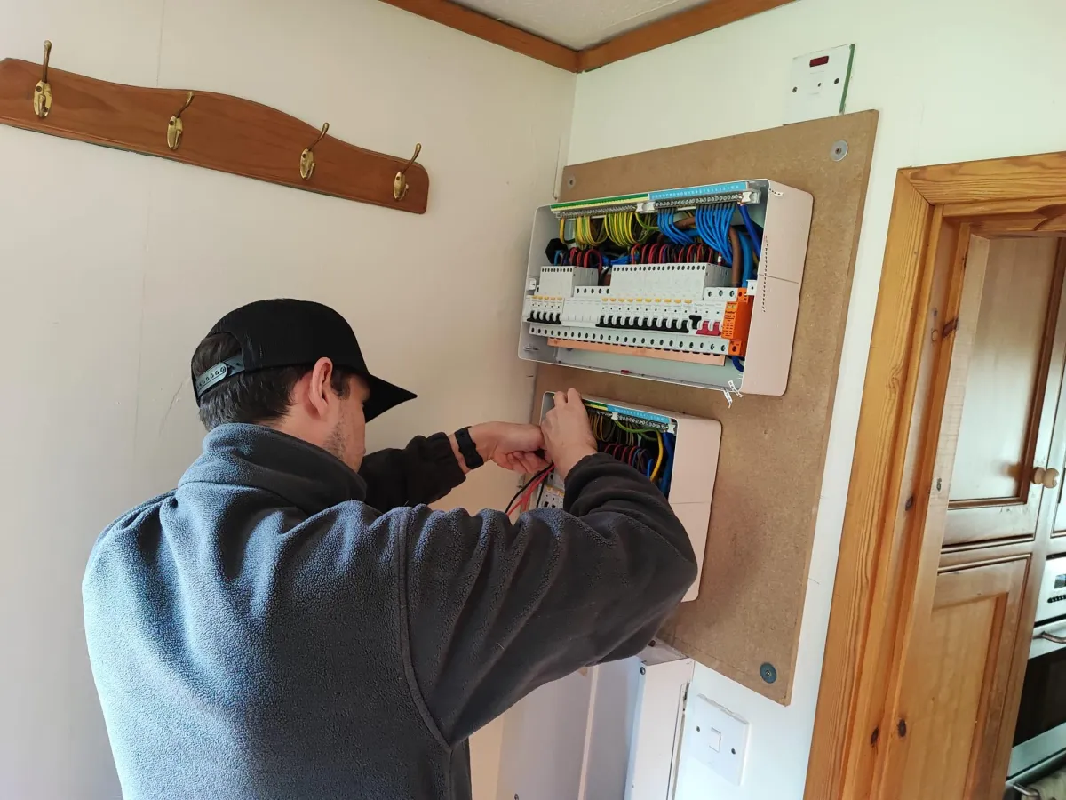 Team member fixing a fuse board for a client.  