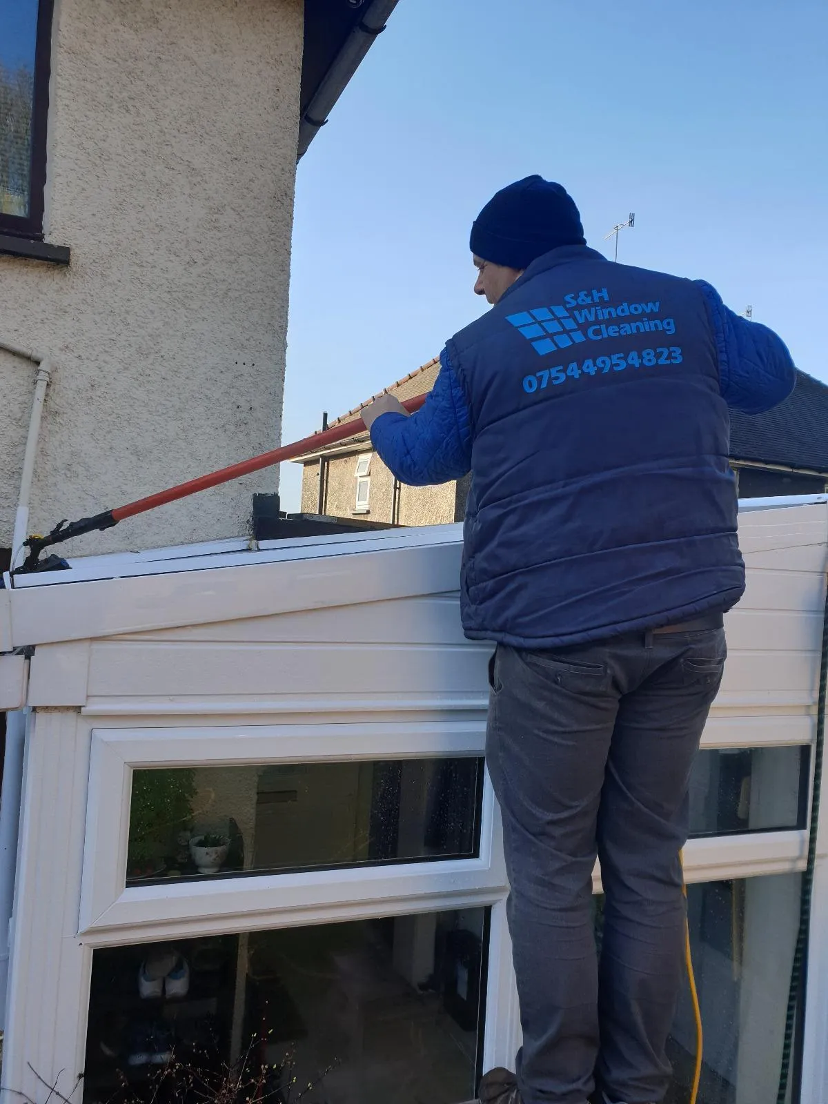 team member cleaning a conservatory roof 